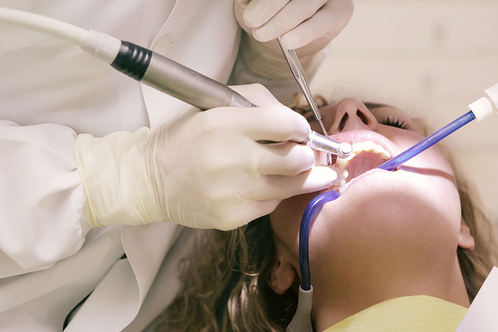 emer man getting his teeth examined