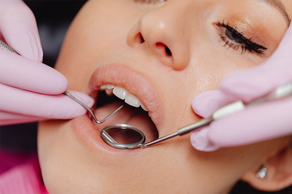 a girl getting her teeth examined