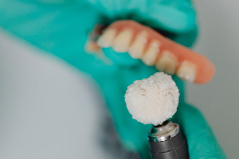 Dentist polishing dentures