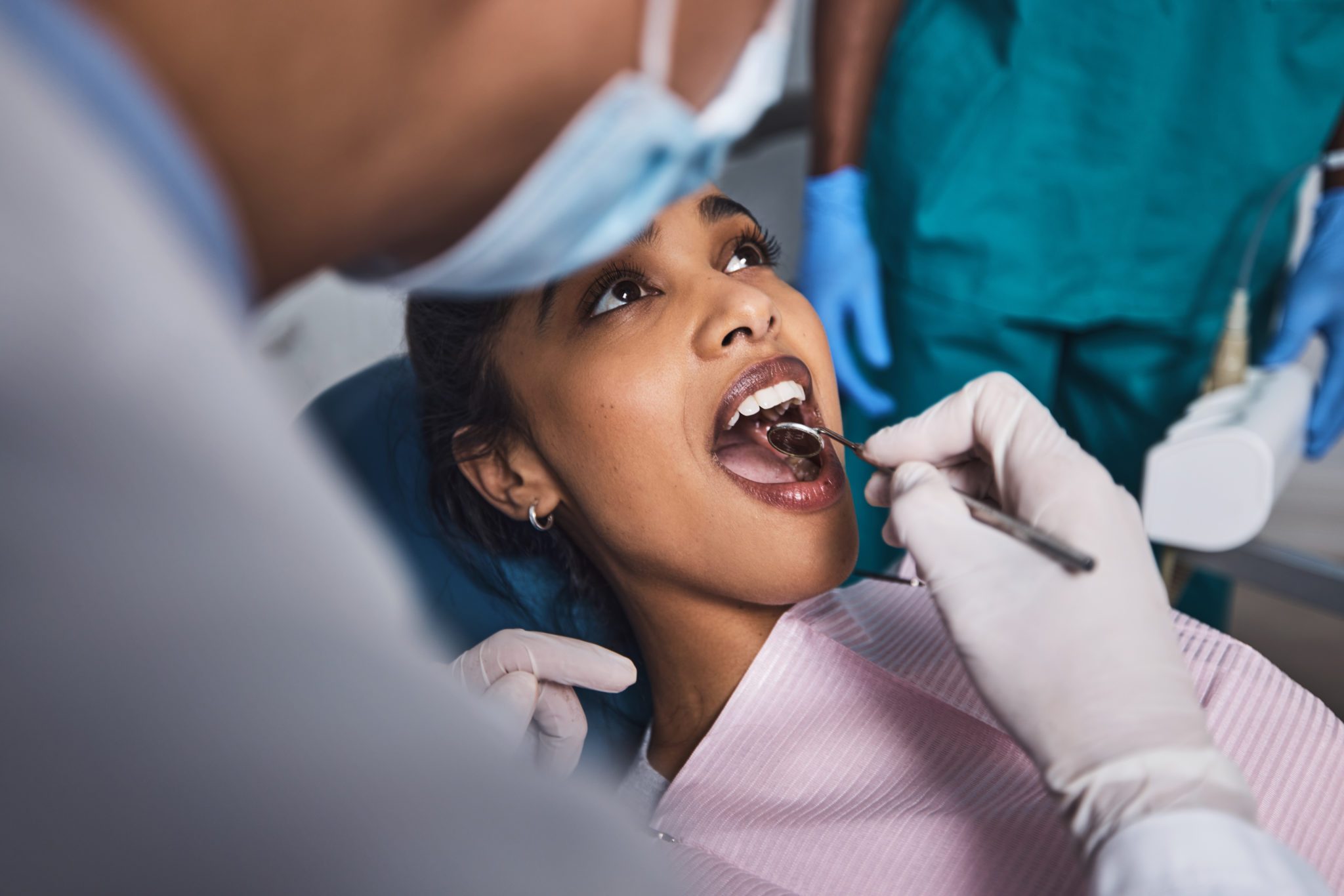 Young woman getting her teeth examined